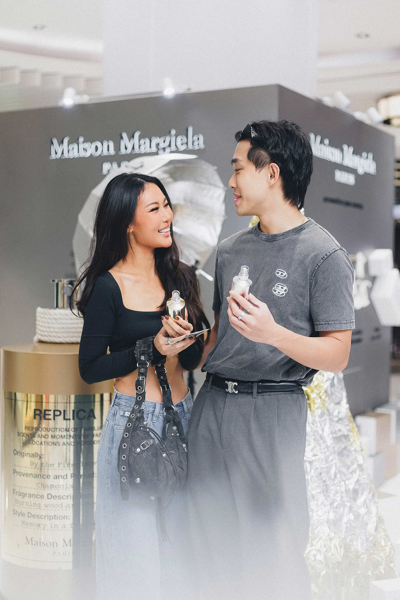 Influencers posing with perfume at Maison Margiela pop-up stall in Ngee Ann City