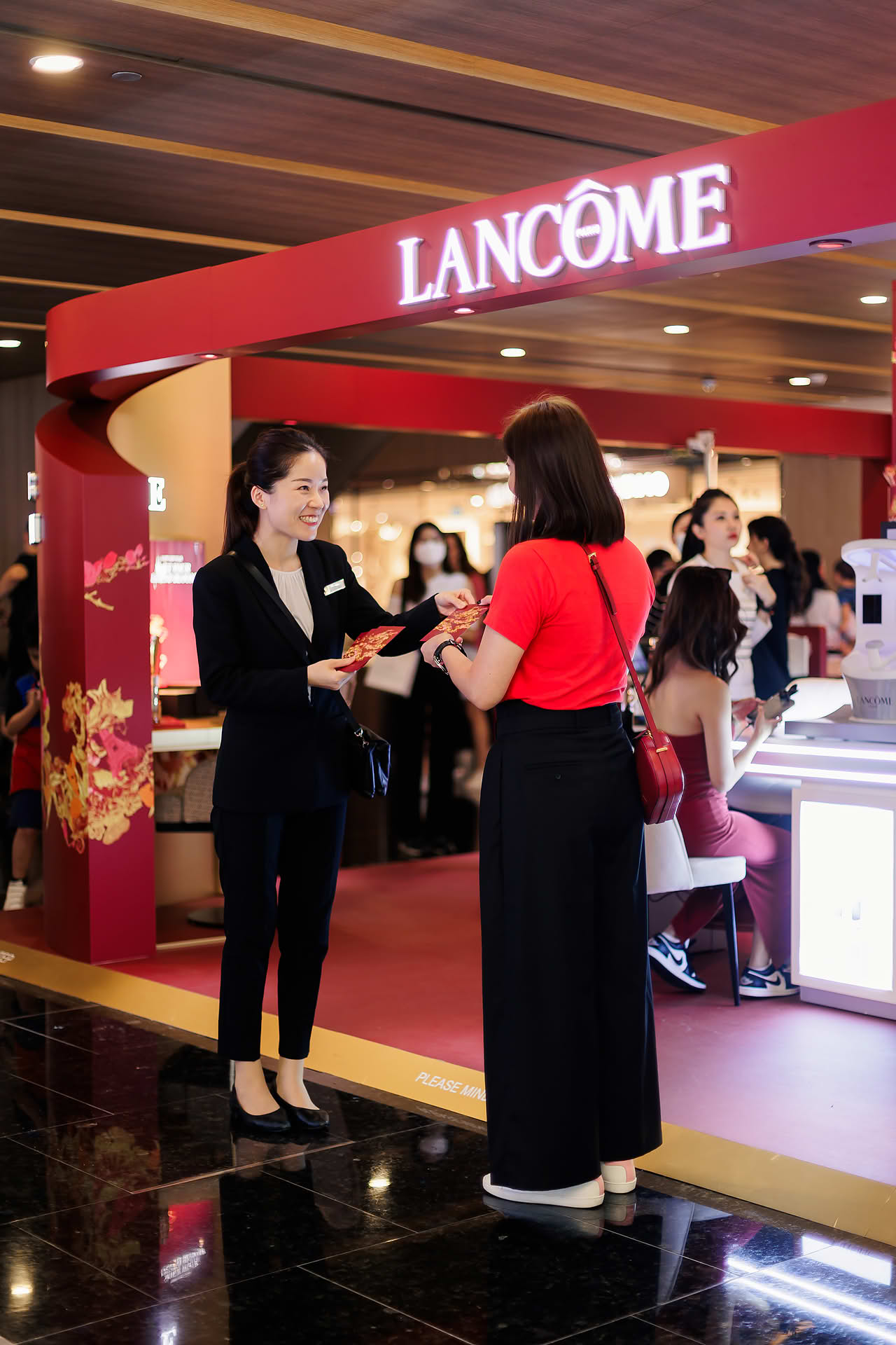 Guest receiving red packet at Lancome Chinese New Year lion dance celebration