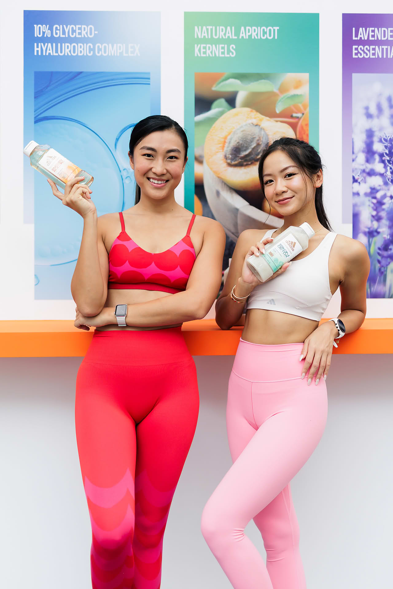 Influencers posing with product at Adidas Pop-up stall