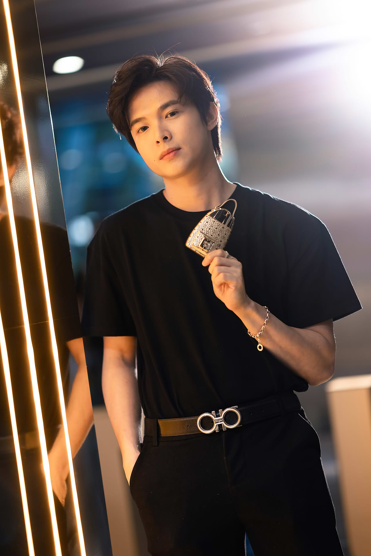 Influencer posing with MCM Ultra perfume to promote pop-up store