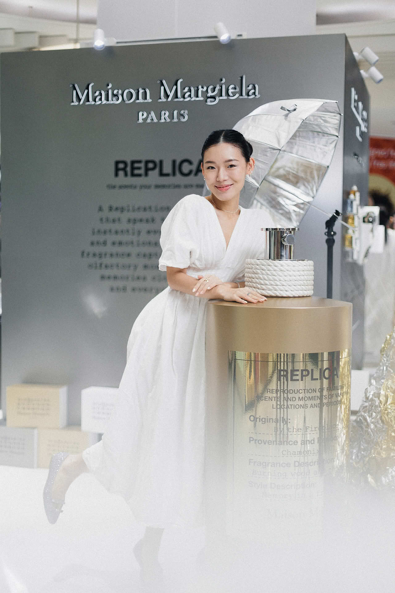 Influencer posing at Maison Margiela pop-up stall in Ngee Ann City
