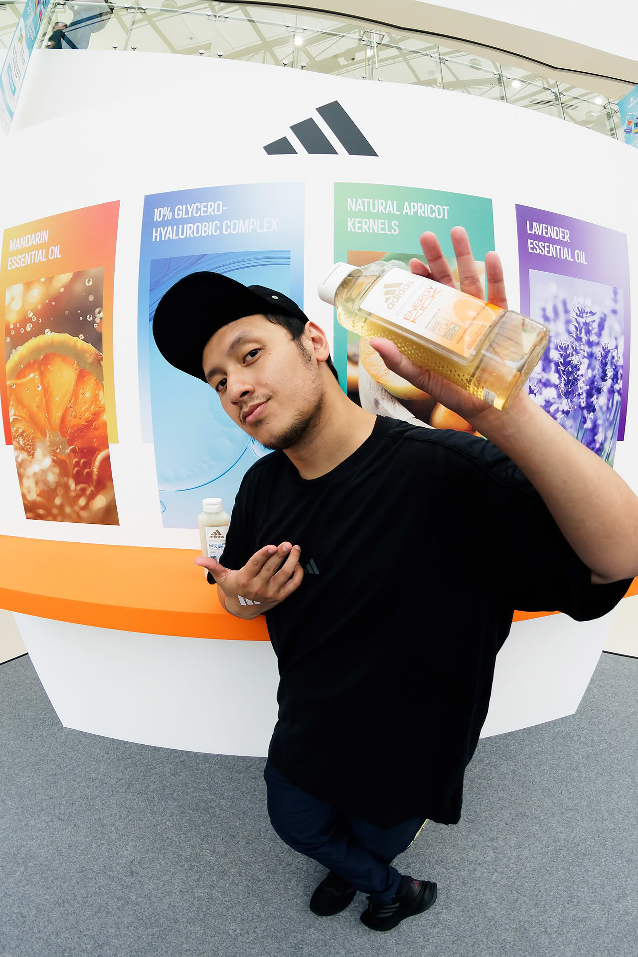 Dance instructer posing with product at Adidas Pop-up stall