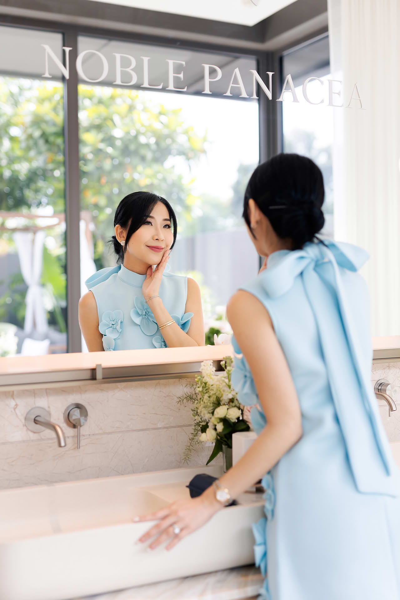 Influencer looking in the mirror at Noble Panacea PR event