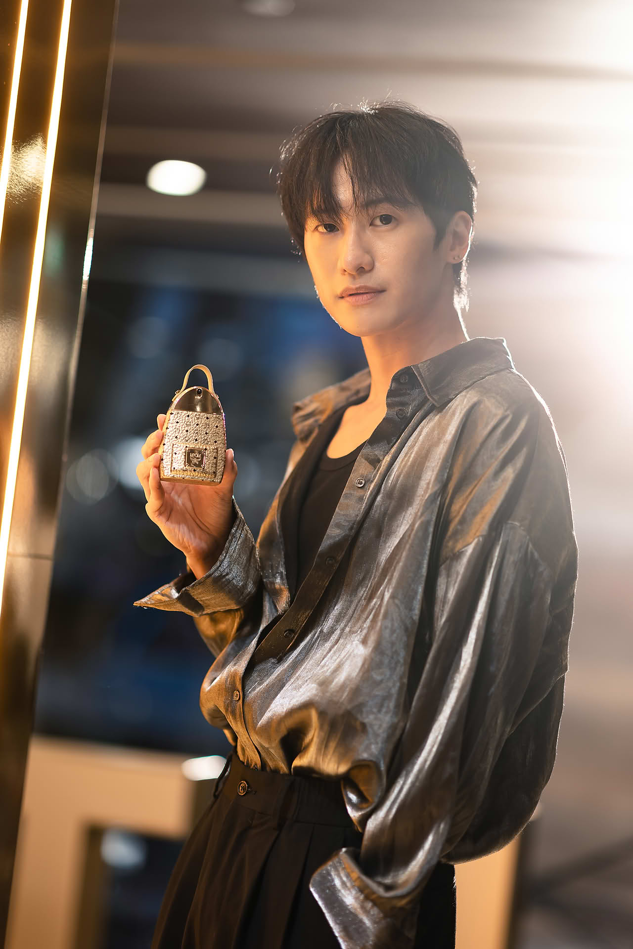 Influencer posing with MCM Ultra perfume to promote pop-up store