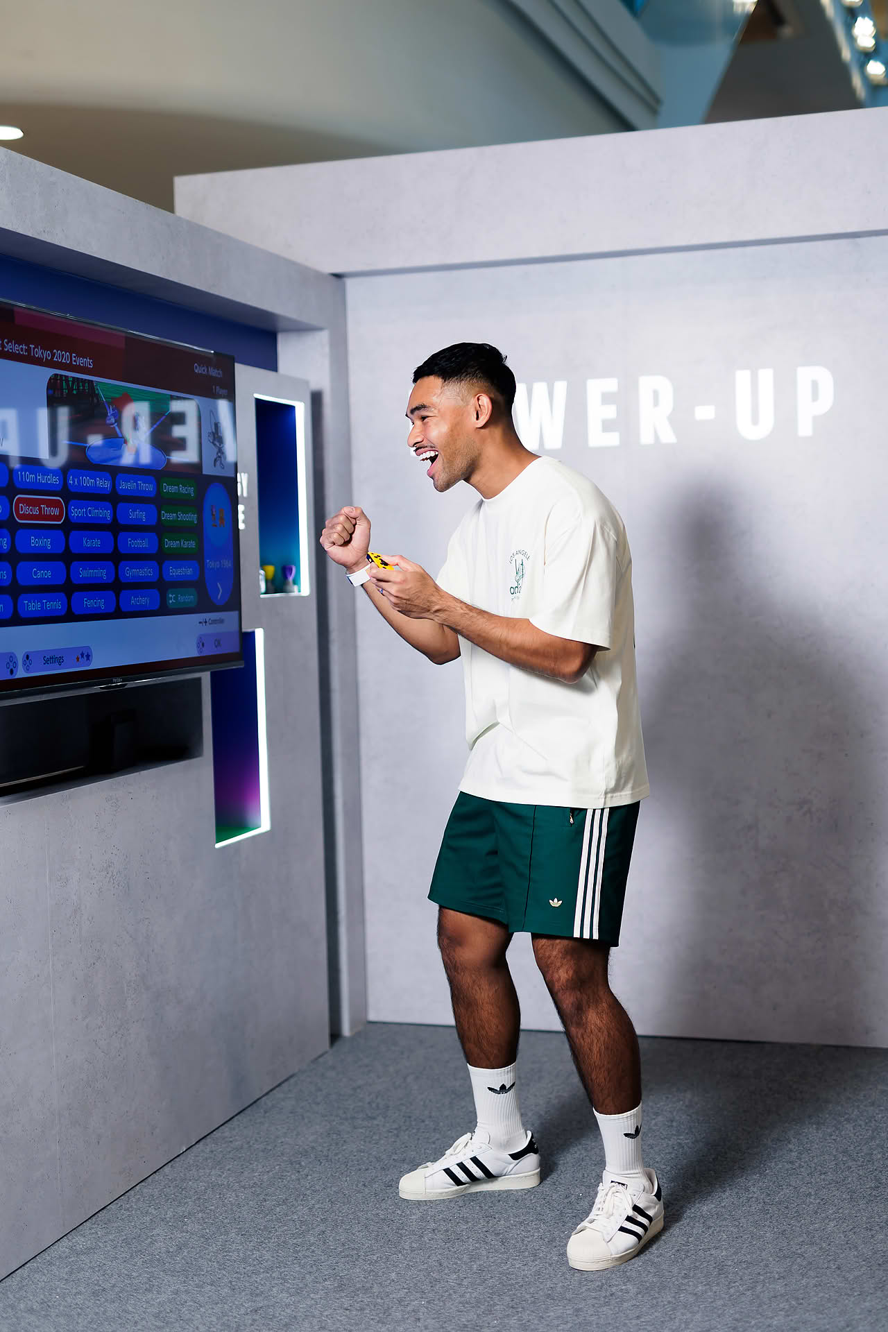 KOL playing video game at Addidas Vibe pop-up stall in Plaza Singapura