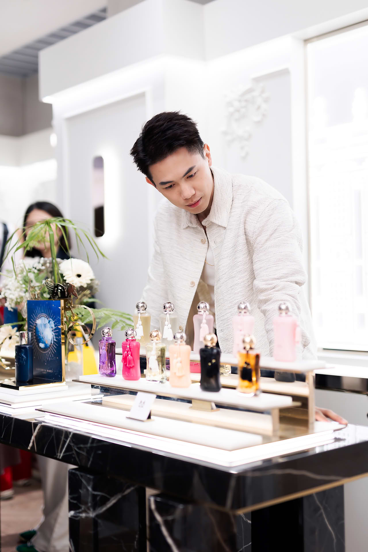 Actor looking at perfume at Parfums de Marly launch event