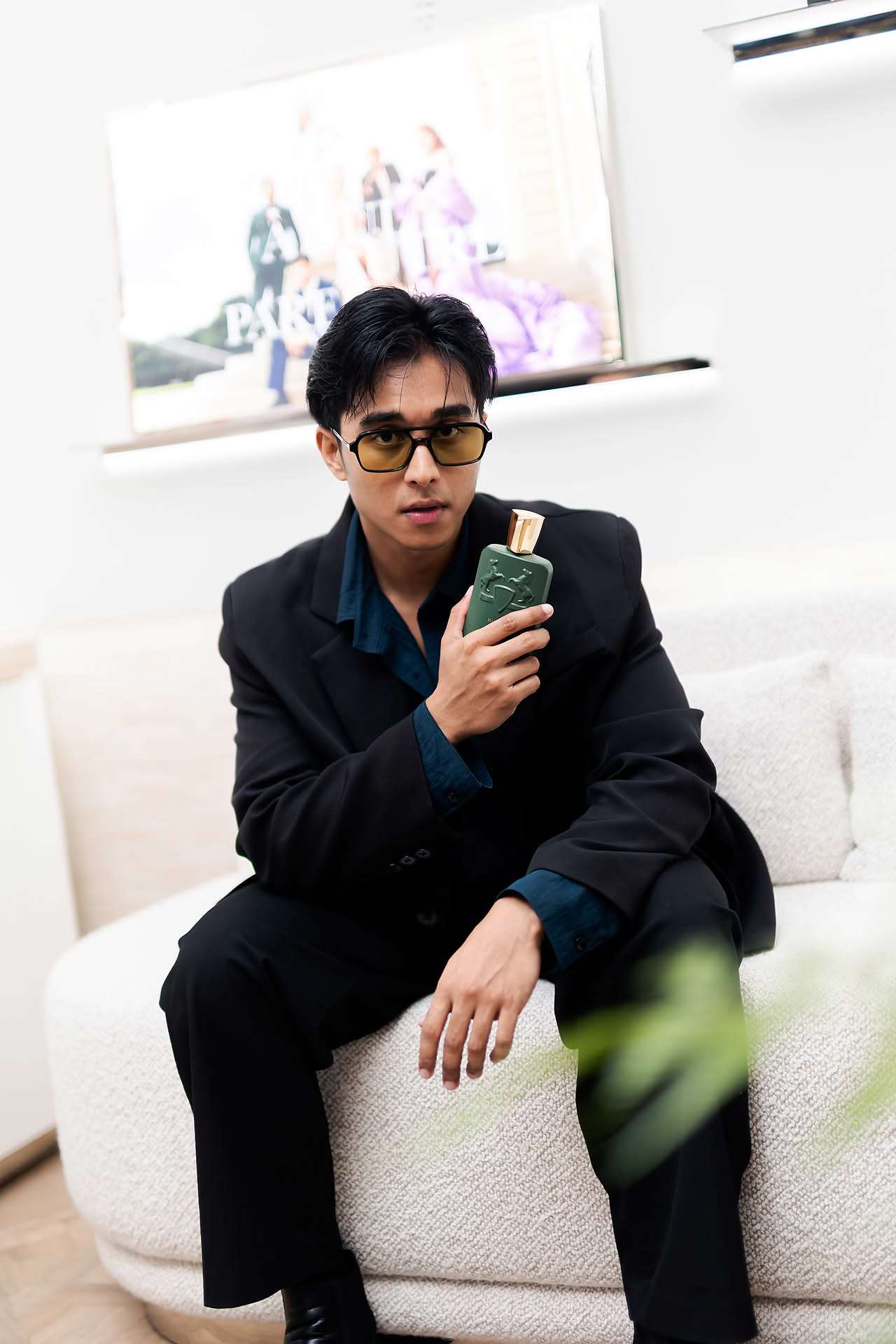 Celebrity posing with perfume at Parfums de Marly launch event