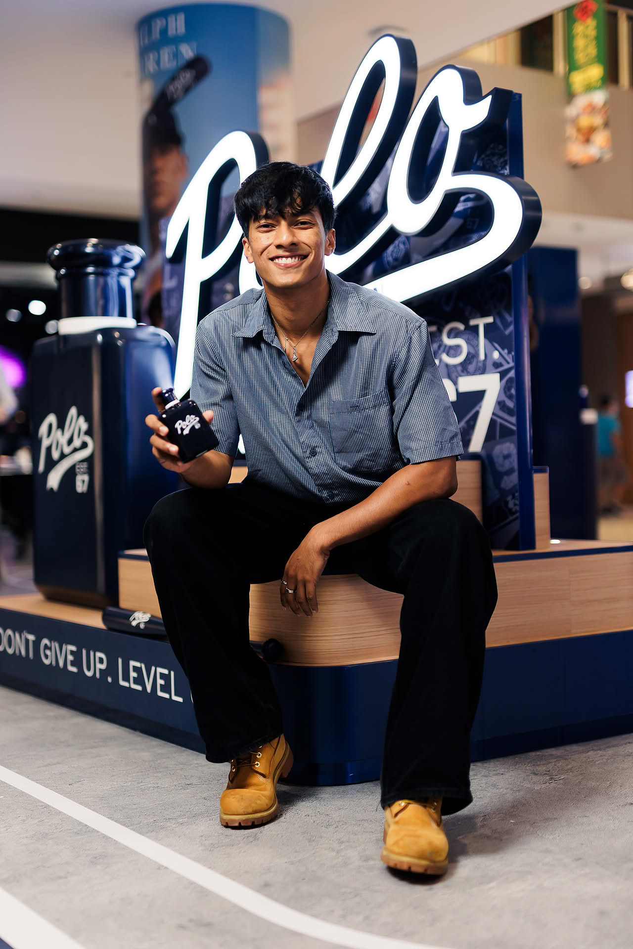 Influencer posing with Ralph Lauren Perfume at pop-up stall in Vivocity