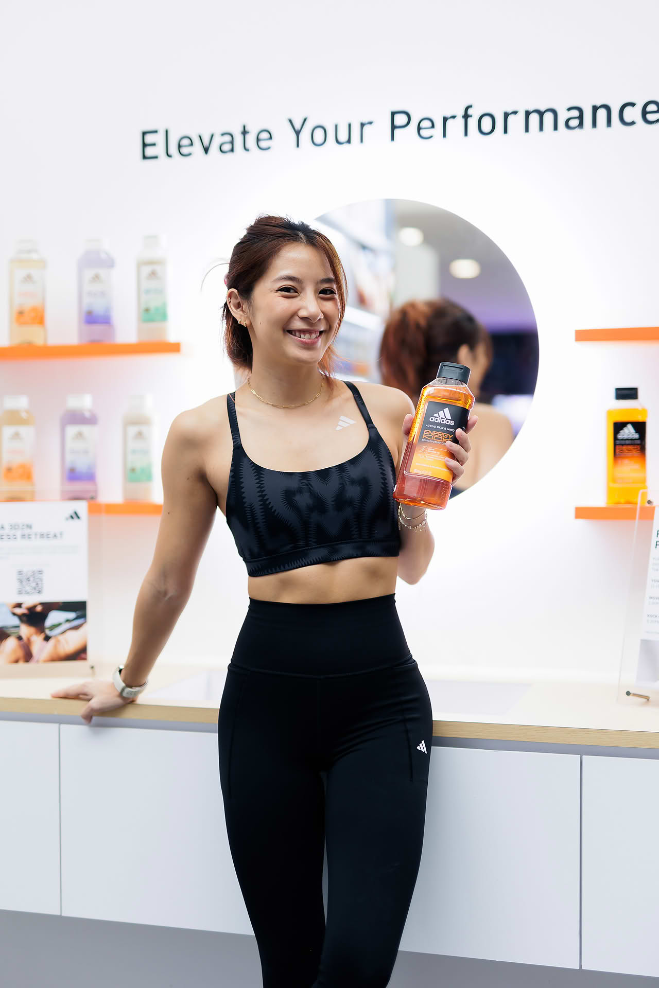 Influencer posing with product at Adidas Pop-up stall