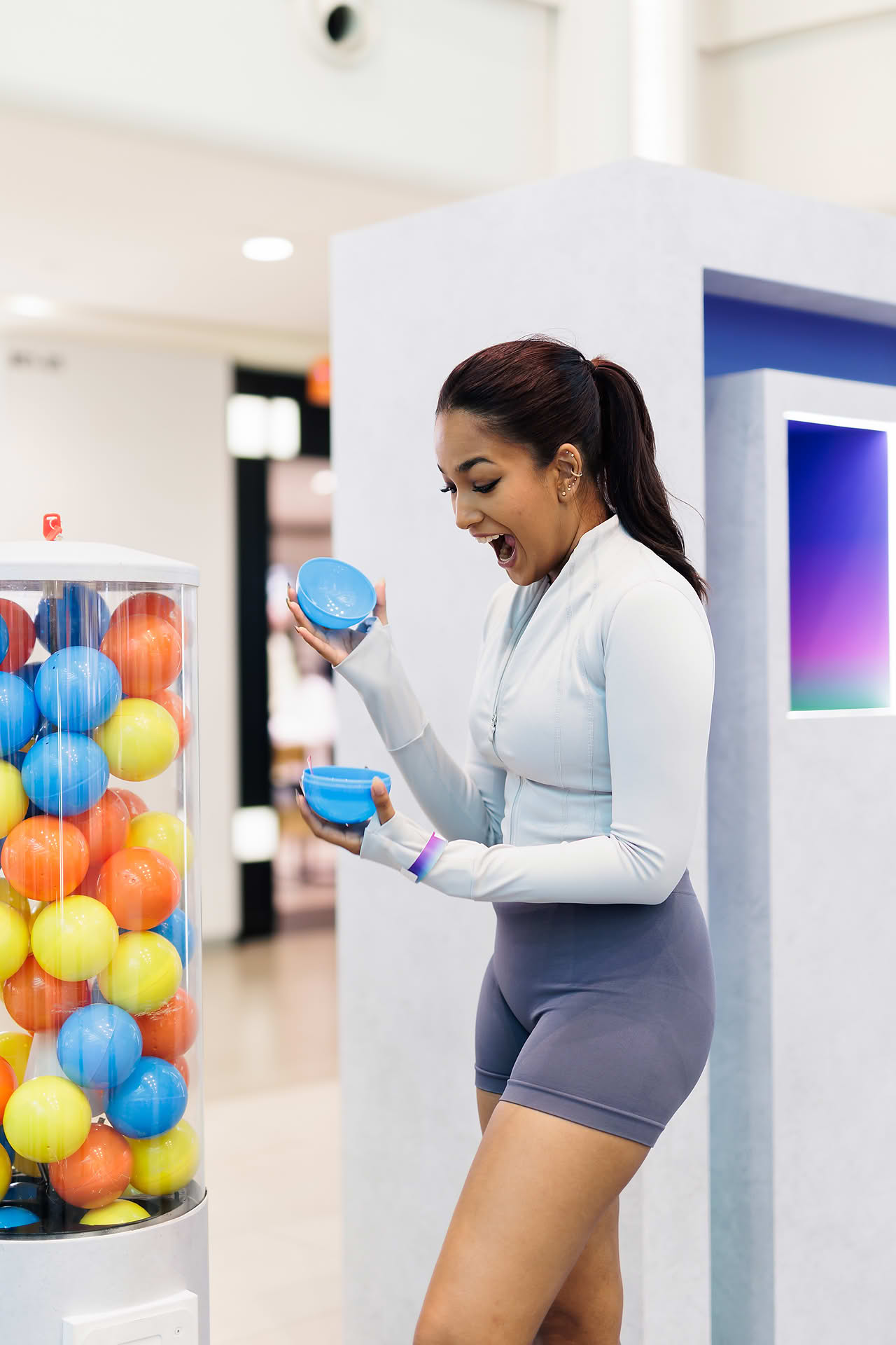Influencer  winning gashapon prize at Addidas Vibe pop-up stall in Plaza Singapura