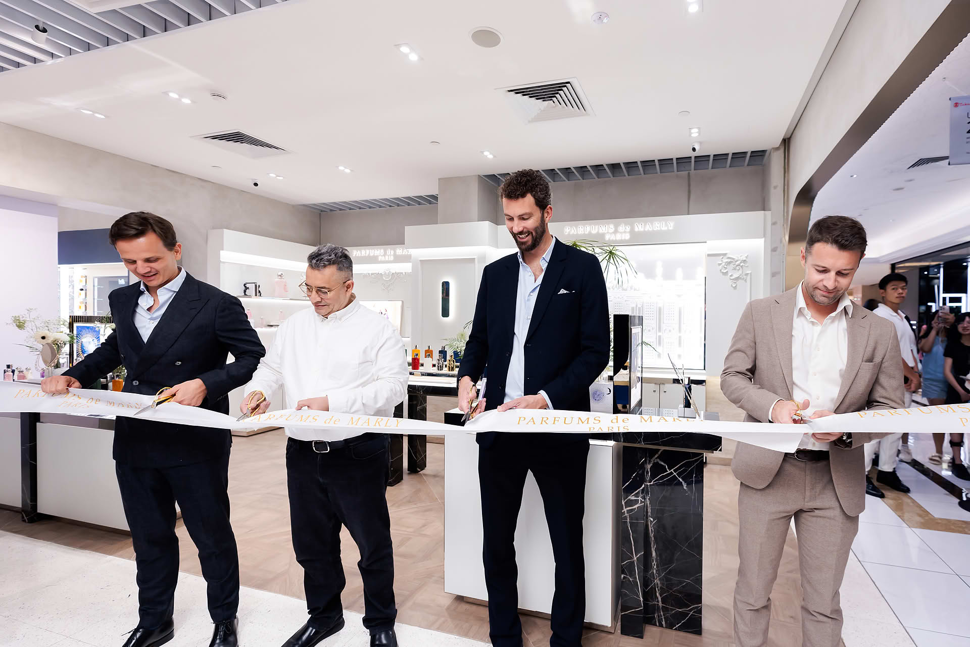 Cutting ribbon at Parfums de Marly launch event