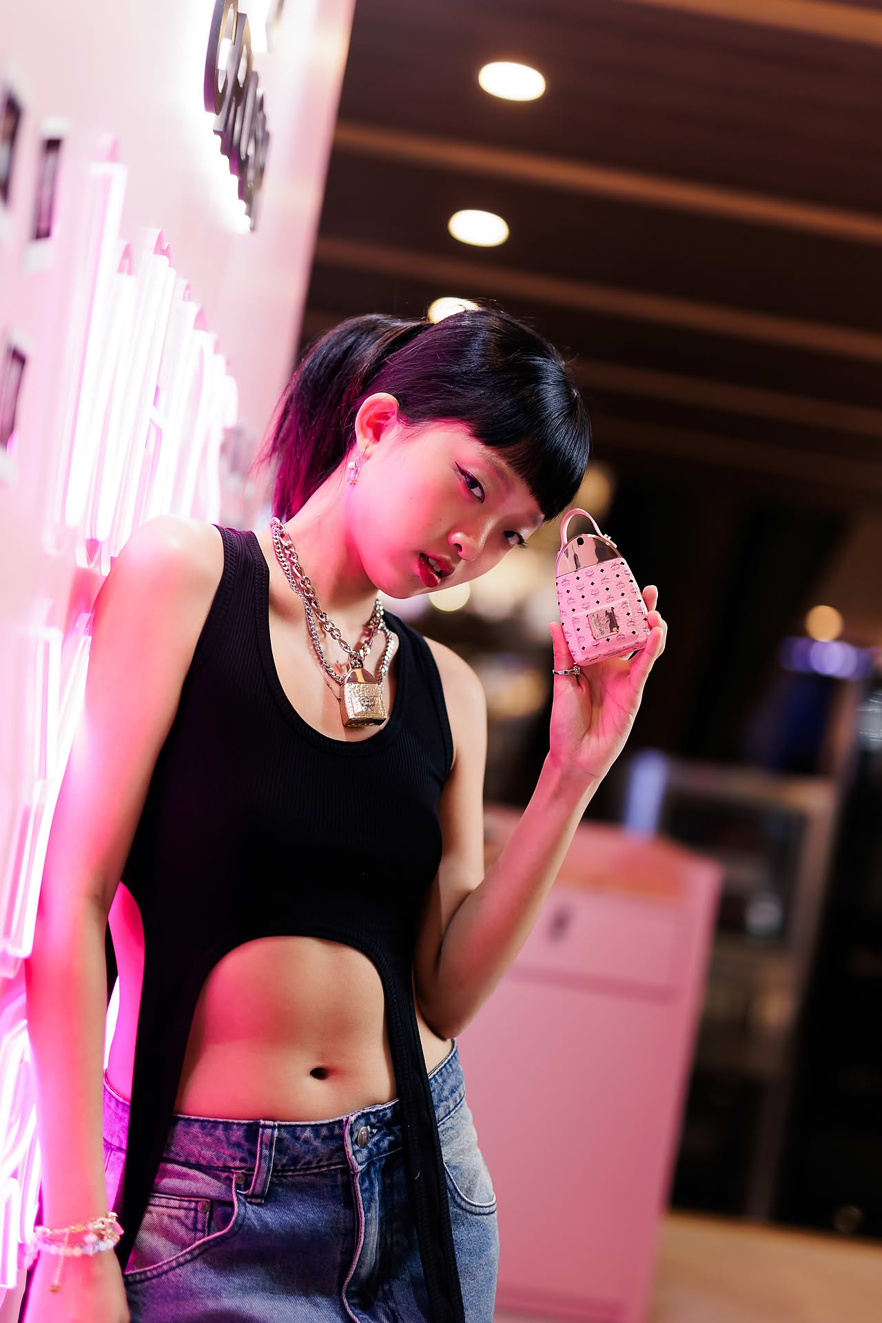 Influencer posing with MCM Crush perfume at pop-up stall in Ngee Ann City