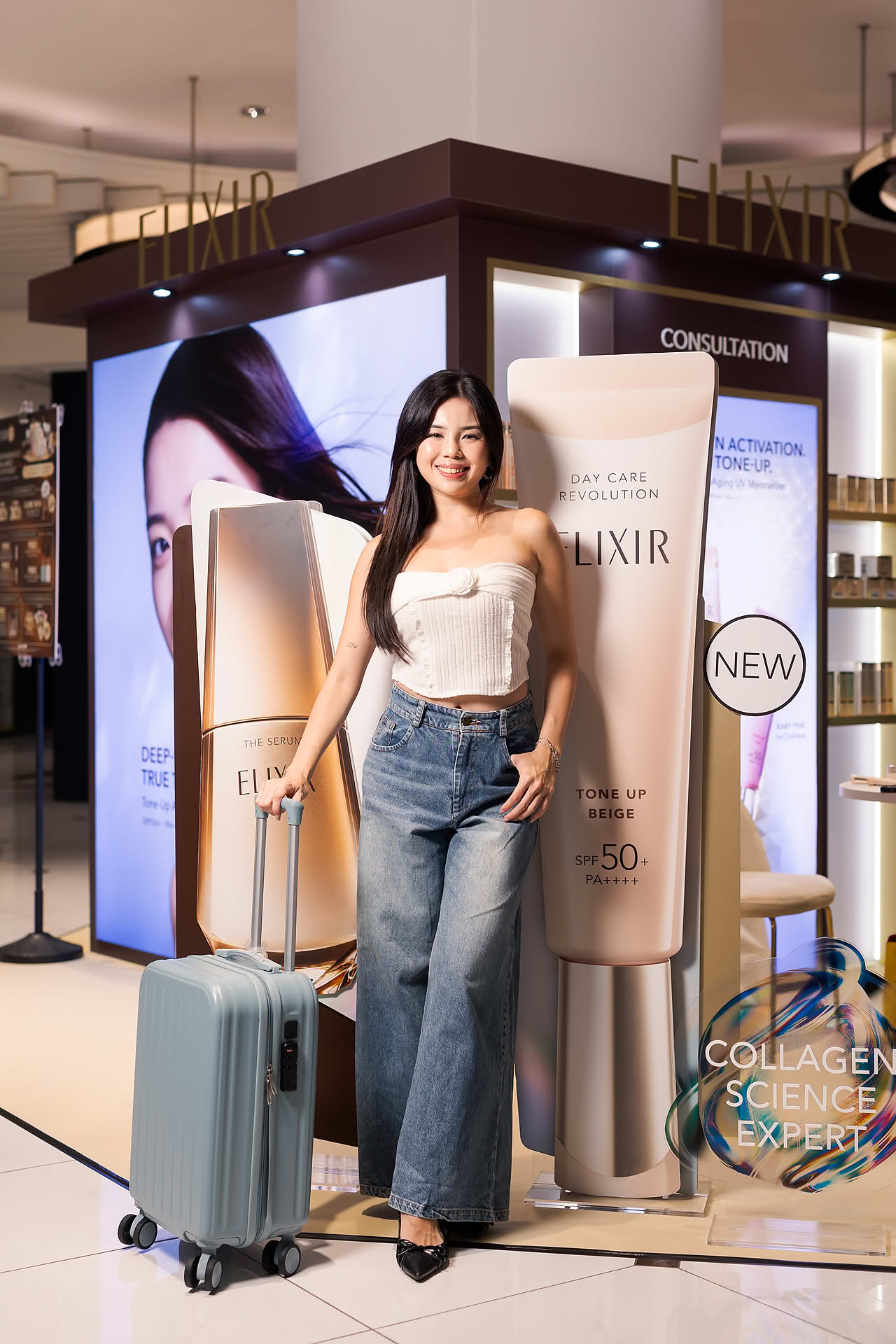 Model with lugguage gift away for Exlixir pop-up stall in Ngee Ann City