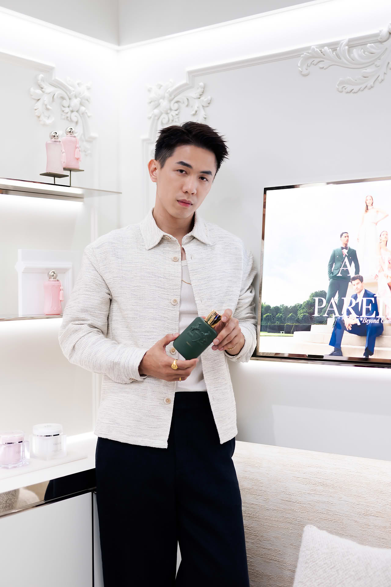 Actor posing with perfume at Parfums de Marly launch event