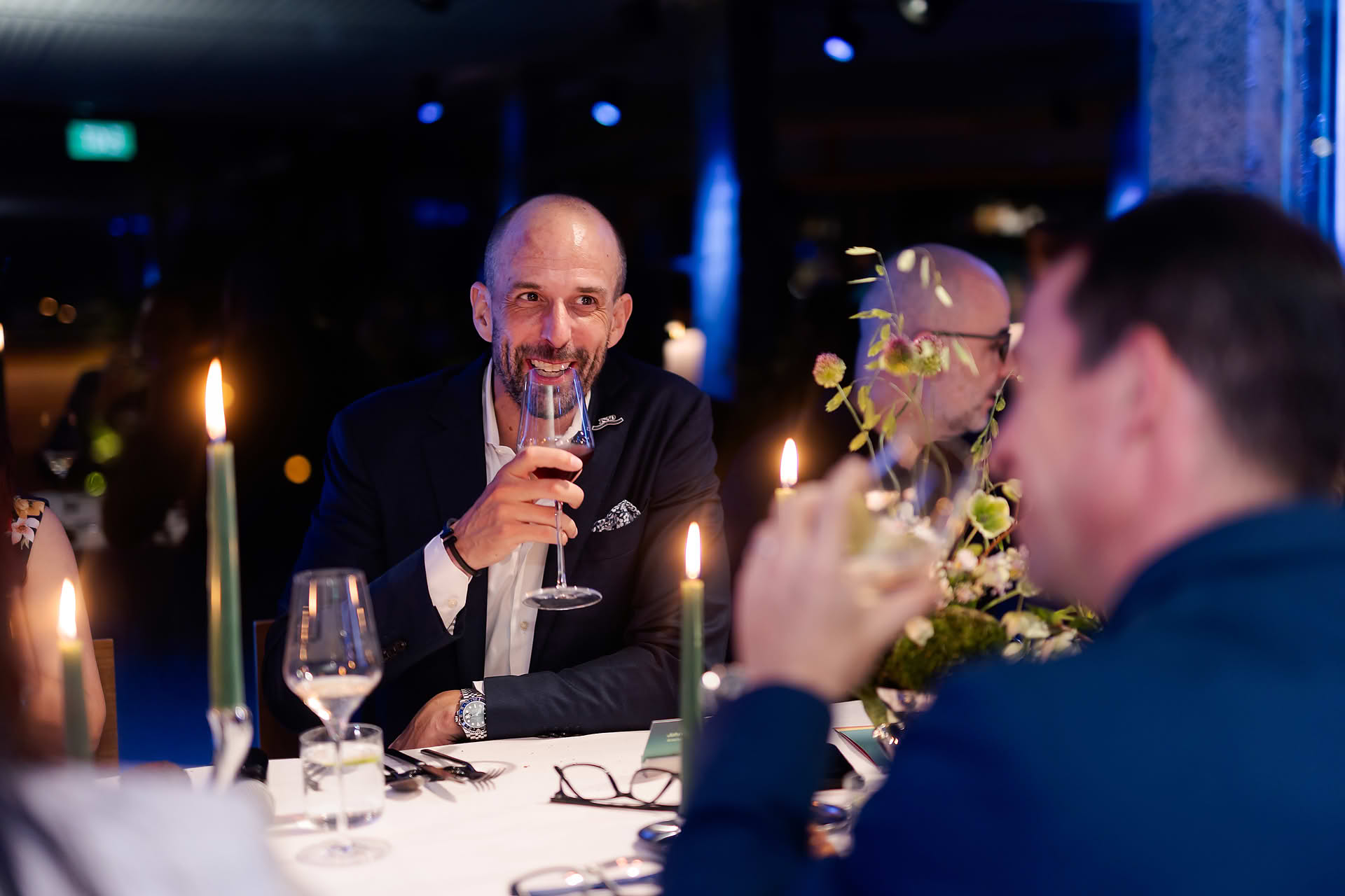 Host having a cup of wine at Amex 1850