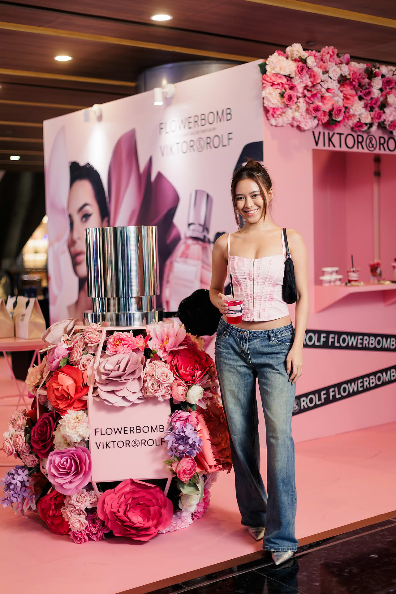 Influencer posing at Vicktor Rolf Cafe pop-up stall in Paragon