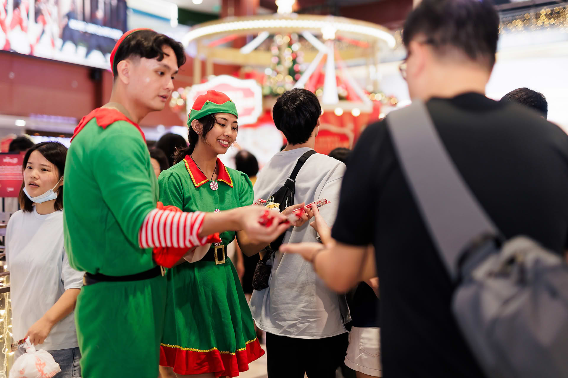 Christmas elves giving KitKat chocolate at Capitaland Mall