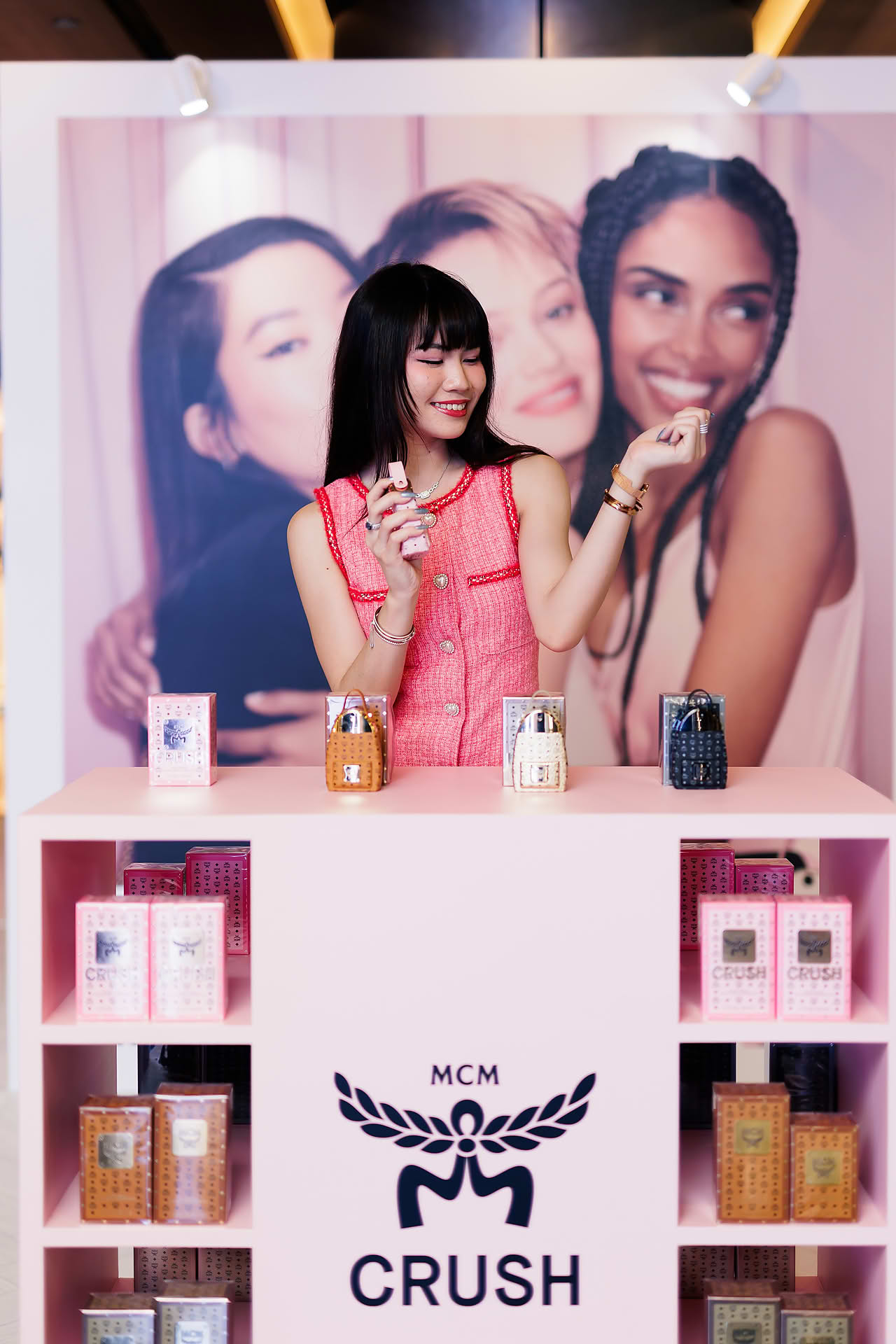 Influencer trying out MCM Crush perfume at pop-up stall in Ngee Ann City