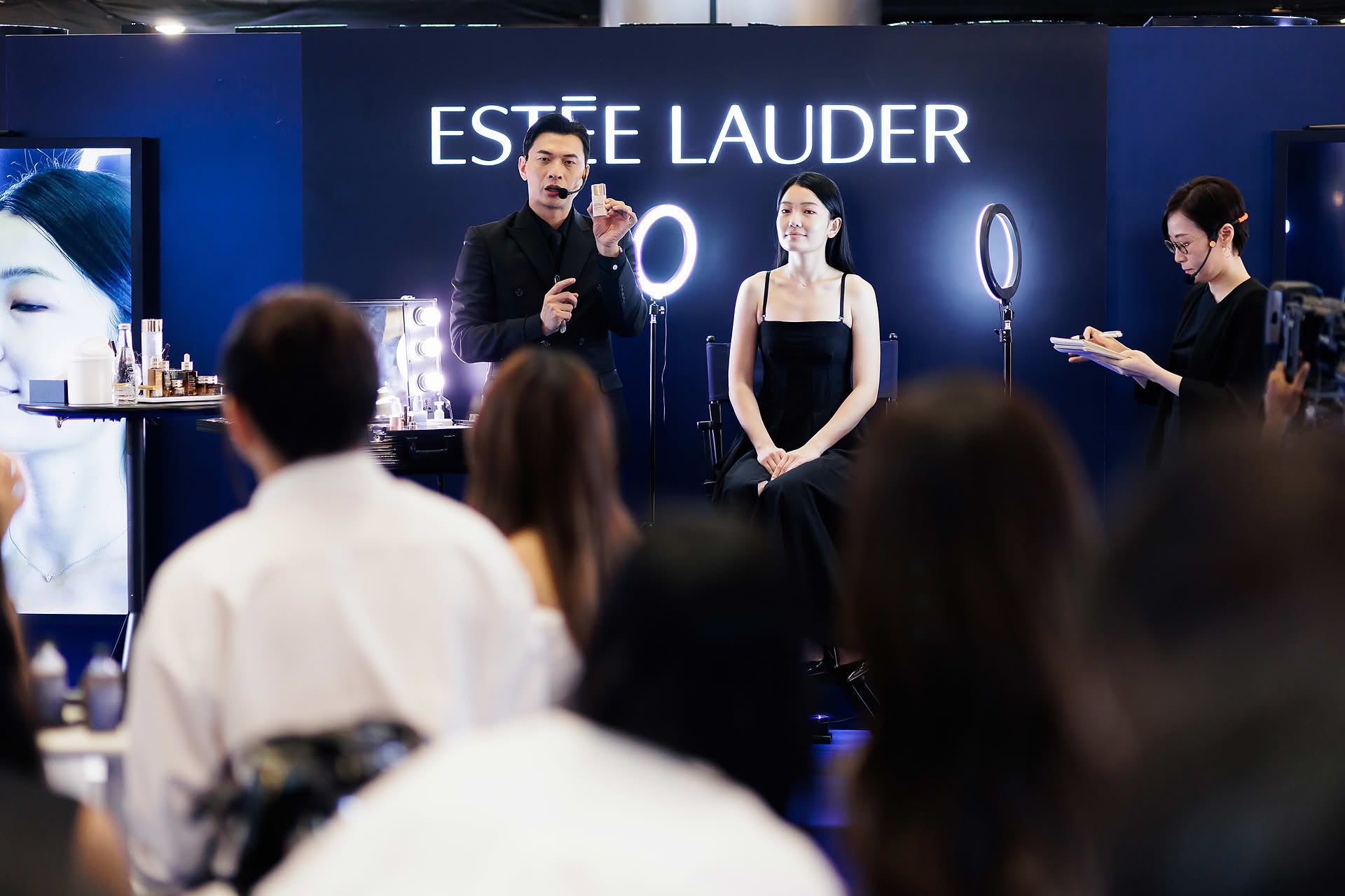 Makeup artist teaching at Estee Lauder PR event