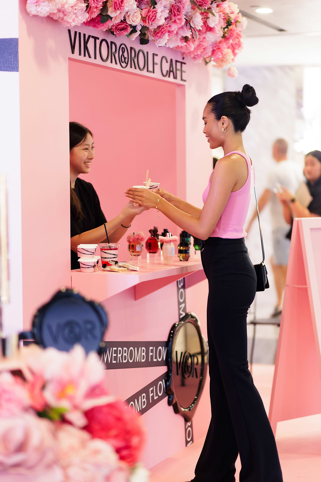 Model receiving food served at Vicktor Rolf Cafe pop-up stall in Paragon