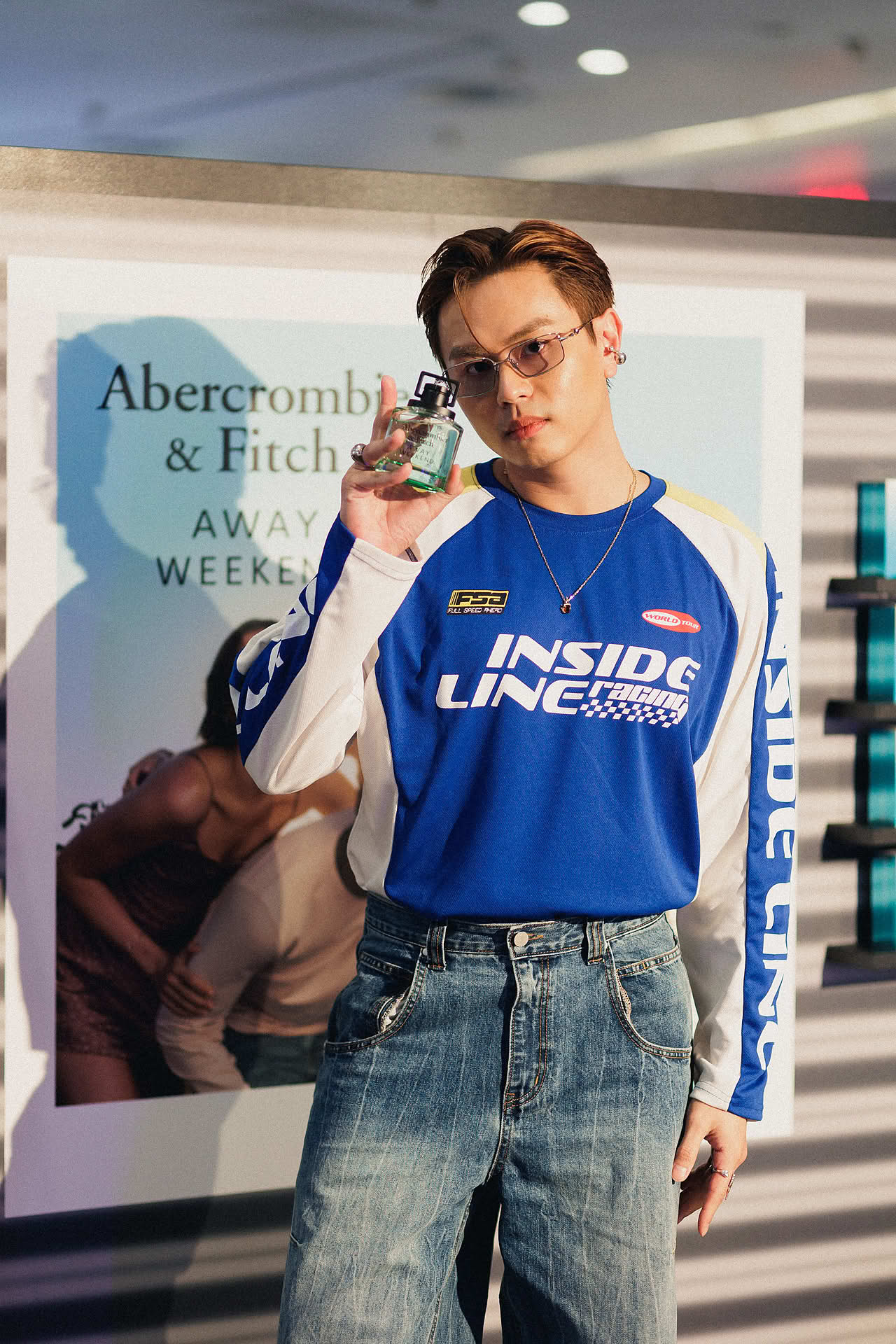 Influencer posing with Abercrombie and Fitch perfume