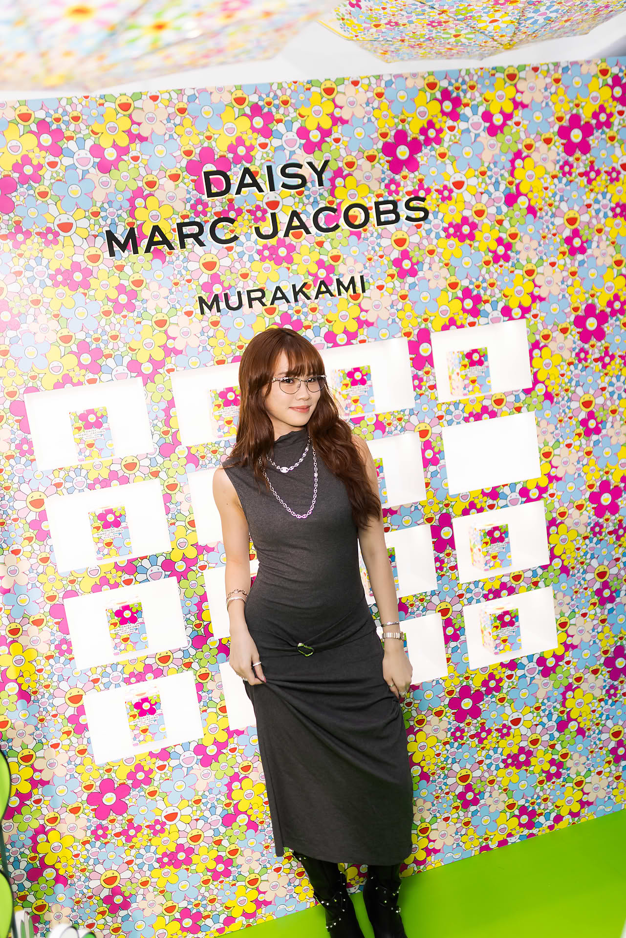 Influncer taking a photo at photo wall at Marc Jacobs pop-up stall
