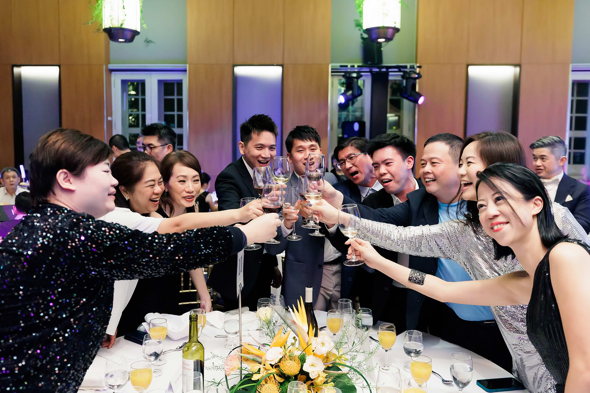 People cheering at SG Land dance and dinner party