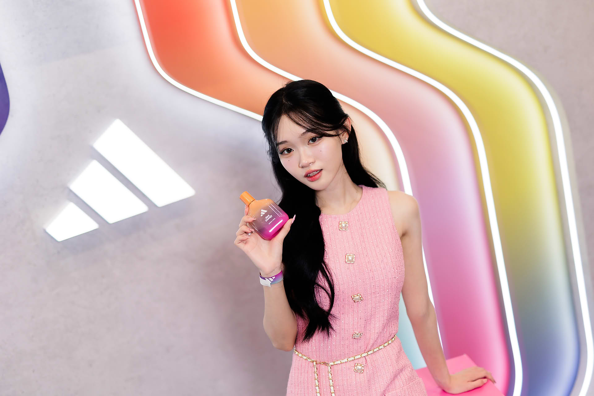 Influencer posing with perfume at Addidas Vibe pop-up stall in Plaza Singapura