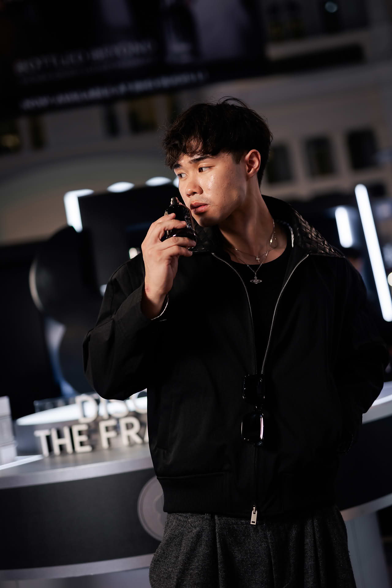 Influencer sniffing perfume at BOSS pop-up stall in Bugis Junction