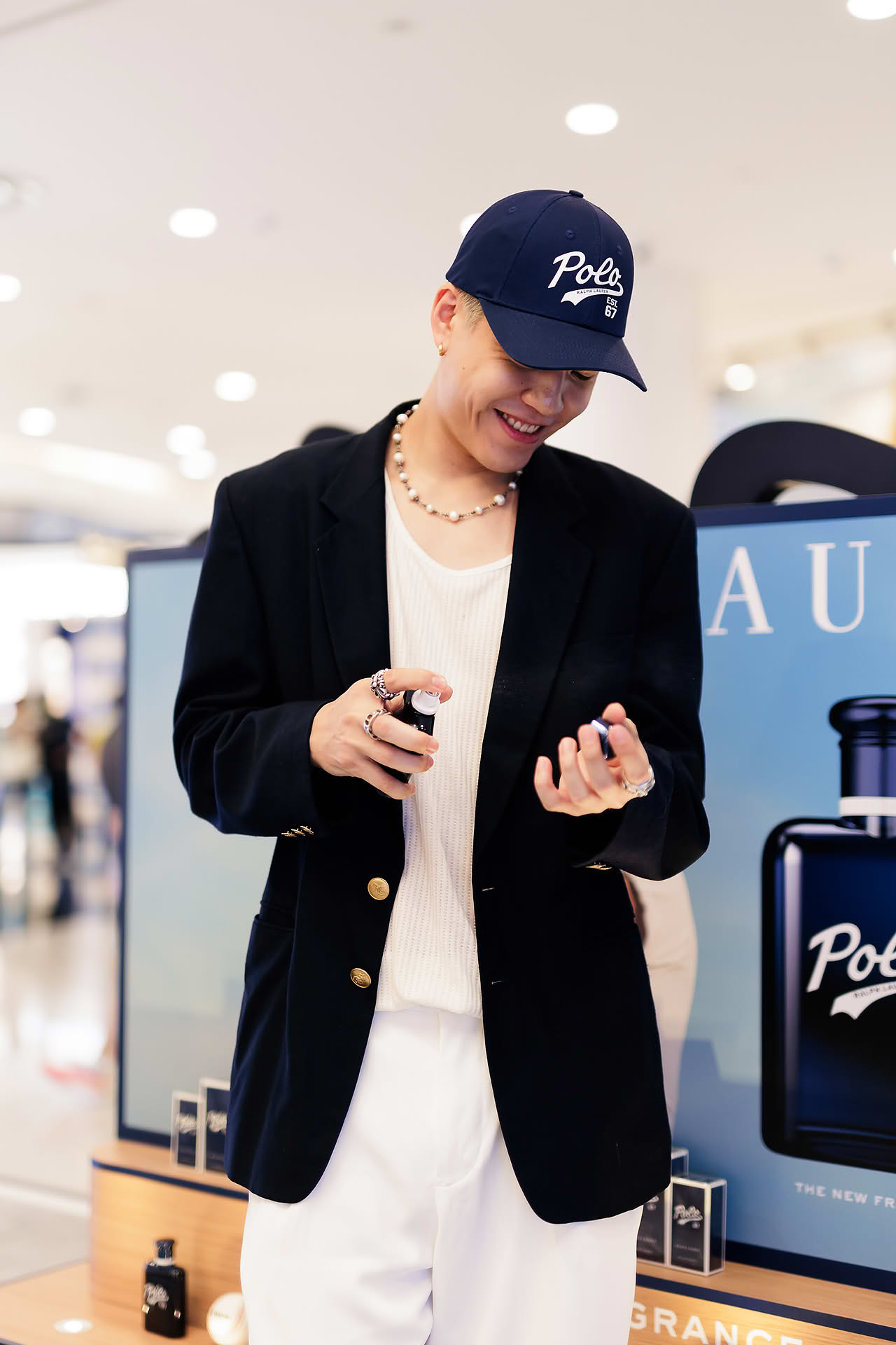 Influencer trying Ralph Lauren Perfume at pop-up stall in Vivocity