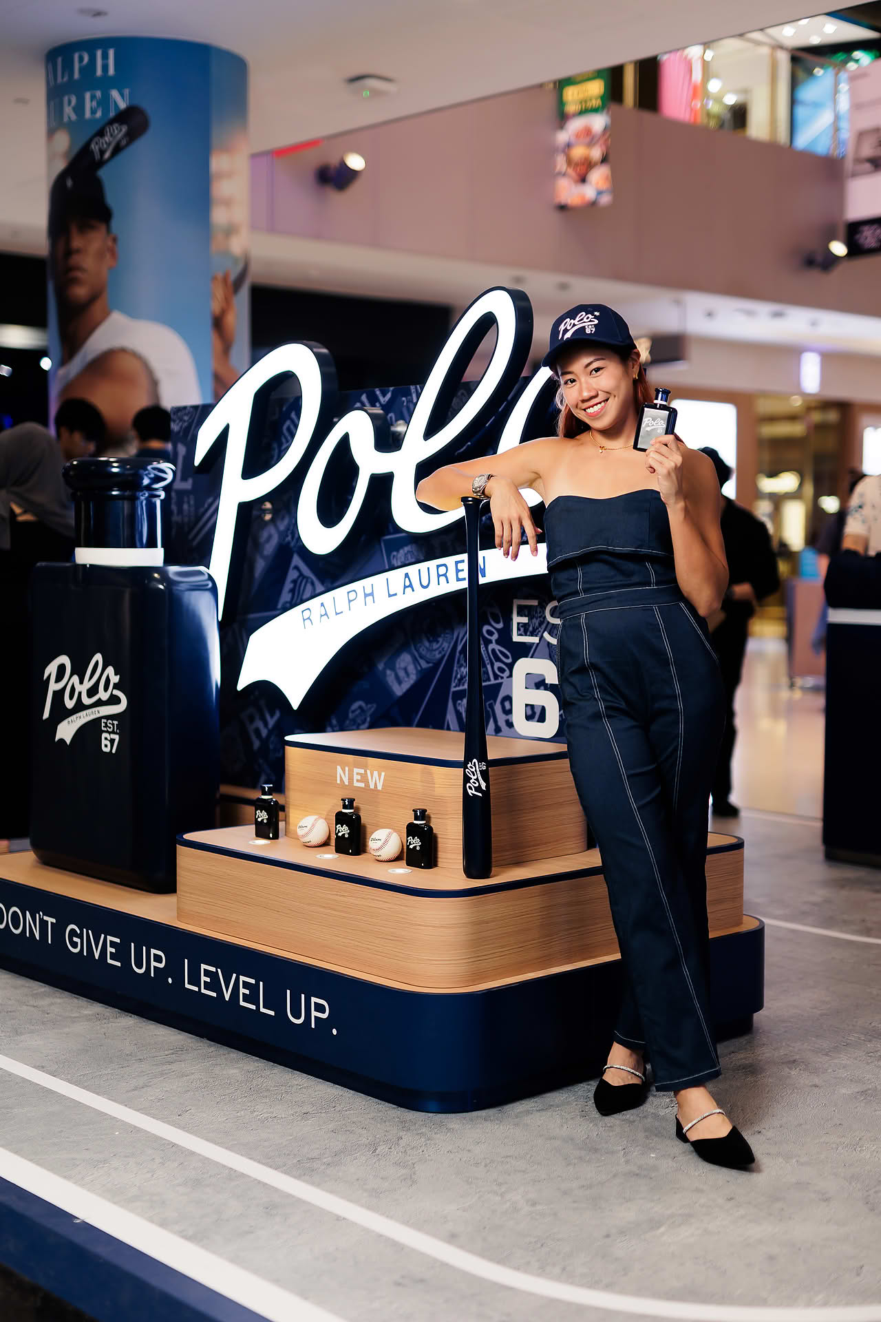 Influencer posing with Ralph Lauren Perfume at pop-up stall in Vivocity